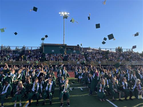 students throwing caps at graduation